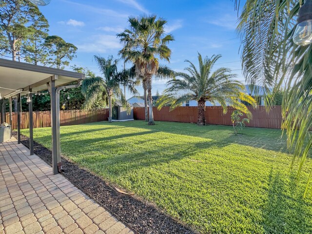 1726 SW Erie St, Port Saint Lucie, FL 34953 - view of yard with a patio