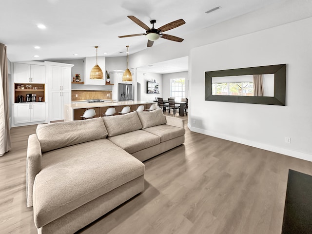 1726 SW Erie St, Port Saint Lucie, FL 34953 - living area featuring a ceiling fan, light wood-type flooring, baseboards, and recessed lighting