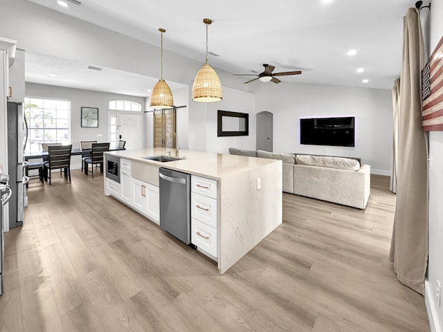 1726 SW Erie St, Port Saint Lucie, FL 34953 - kitchen featuring appliances with stainless steel finishes, a sink, arched walkways, white cabinets, and ceiling fan