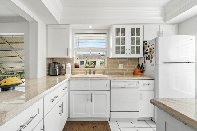 10040 Meridian Way N Unit 206, Palm Beach Gardens, FL 33410 - kitchen with white appliances, a sink, crown molding, white cabinetry, and tasteful backsplash