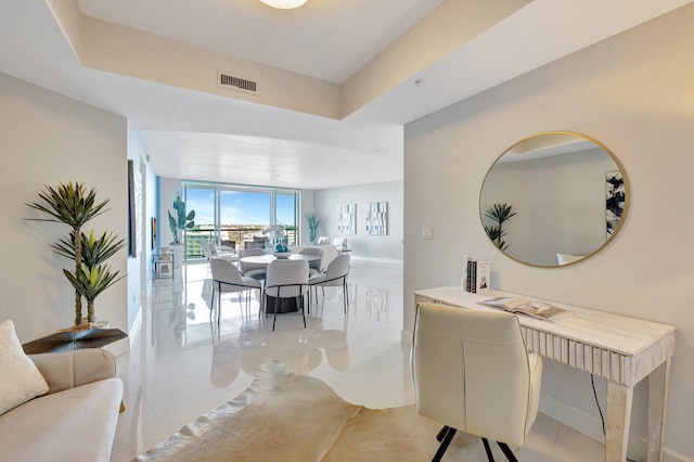 dining space featuring light tile patterned floors and baseboards