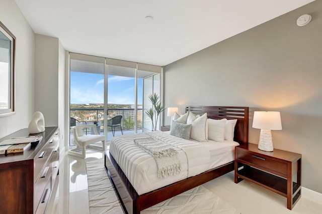 bedroom with a wall of windows and access to outside