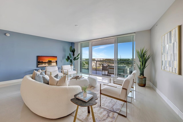 living room featuring floor to ceiling windows and baseboards