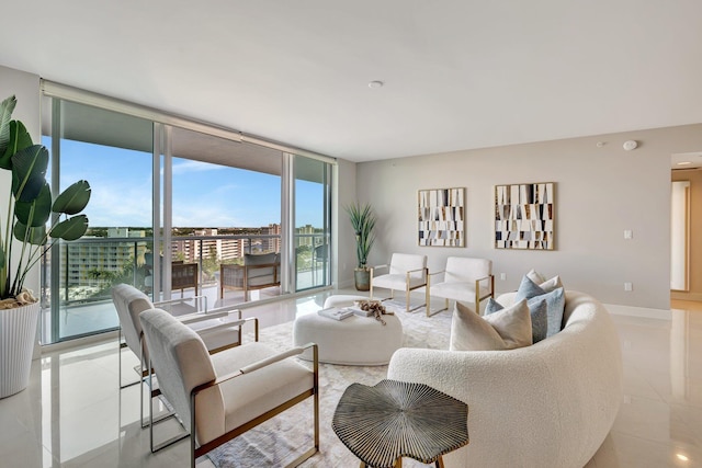 living area with light tile patterned floors, expansive windows, and baseboards