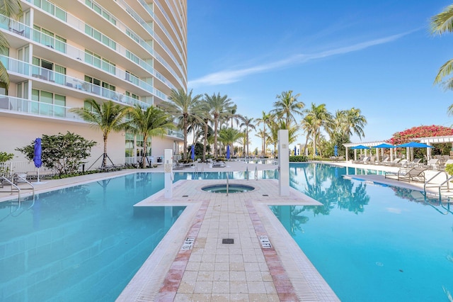 community pool featuring a community hot tub and a patio