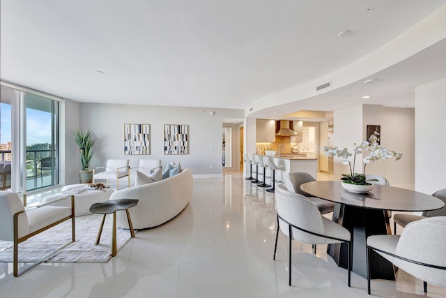 living room featuring baseboards and light tile patterned floors