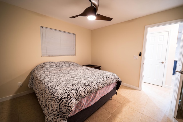 bedroom featuring light tile patterned flooring, a ceiling fan, and baseboards
