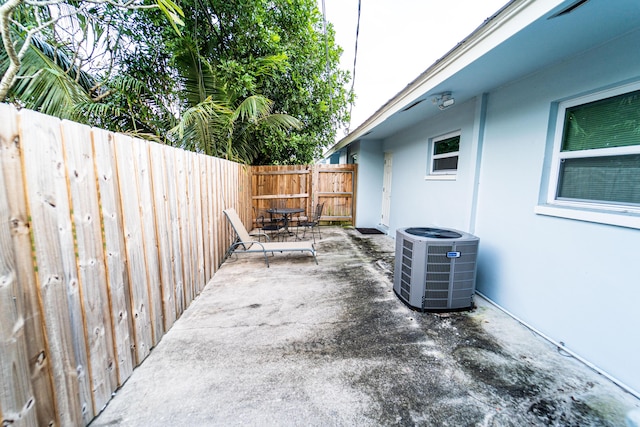 view of patio with cooling unit and a fenced backyard