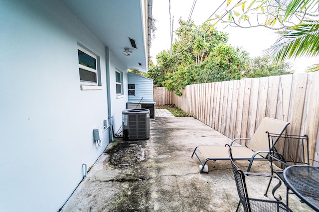 view of patio / terrace with cooling unit and a fenced backyard