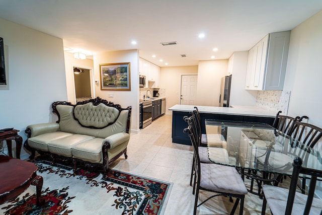 living room featuring light tile patterned floors and recessed lighting
