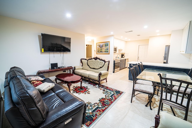 living room featuring light tile patterned flooring and recessed lighting