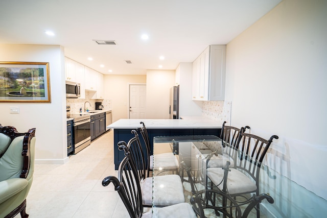 dining area with light tile patterned floors, recessed lighting, and baseboards