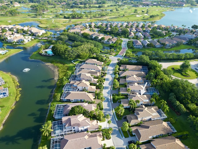 aerial view of property and surrounding area featuring nearby suburban area and a nearby body of water