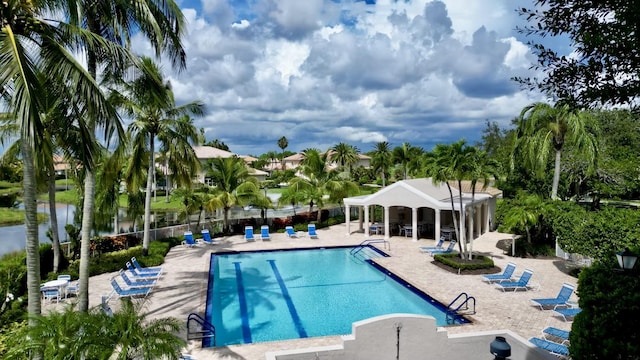 community pool featuring a patio area and fence