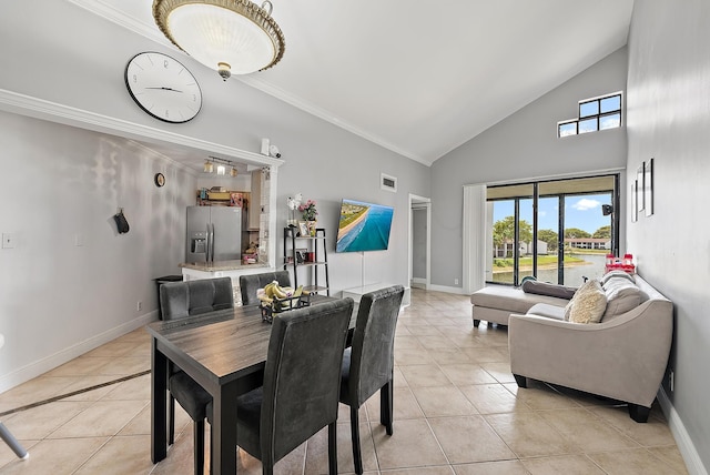 210 Lake Pointe Dr Unit 310, Oakland Park, FL 33309 - dining room with light tile patterned floors, crown molding, baseboards, and high vaulted ceiling