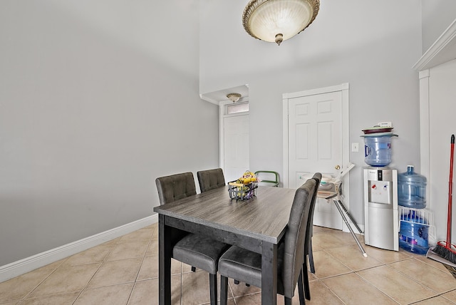 210 Lake Pointe Dr Unit 310, Oakland Park, FL 33309 - dining area with a high ceiling, light tile patterned floors, and baseboards