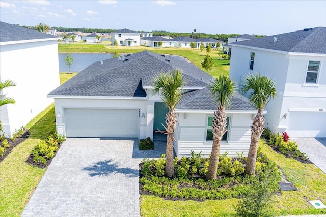 3527 Angler Dr, Fort Pierce, FL 34946 - view of front facade featuring a residential view, a garage, a shingled roof, decorative driveway, and stucco siding