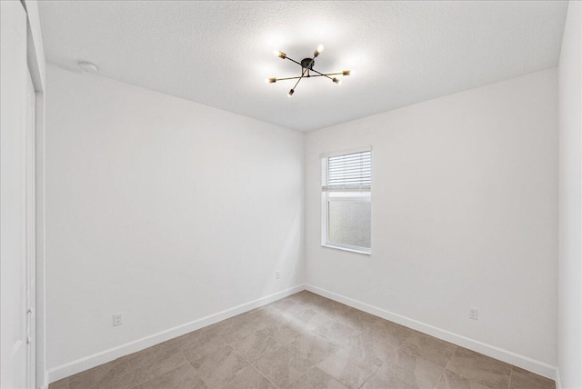 3527 Angler Dr, Fort Pierce, FL 34946 - unfurnished room with a chandelier, baseboards, and a smoke detector