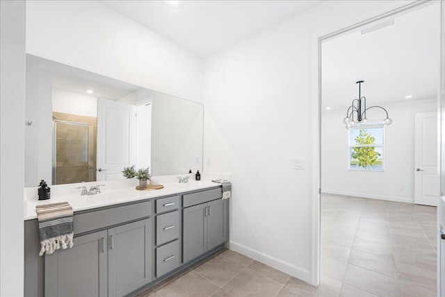 3527 Angler Dr, Fort Pierce, FL 34946 - full bath featuring a stall shower, baseboards, tile patterned floors, double vanity, and a chandelier