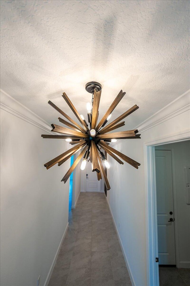 3527 Angler Dr, Fort Pierce, FL 34946 - hall featuring a textured ceiling, baseboards, crown molding, and a chandelier