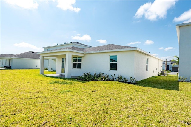 3527 Angler Dr, Fort Pierce, FL 34946 - back of property with a yard, stucco siding, and central AC unit