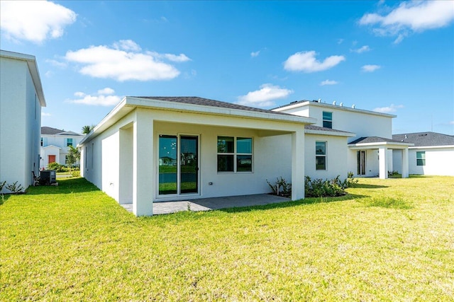 3527 Angler Dr, Fort Pierce, FL 34946 - back of house with a lawn, stucco siding, and a patio