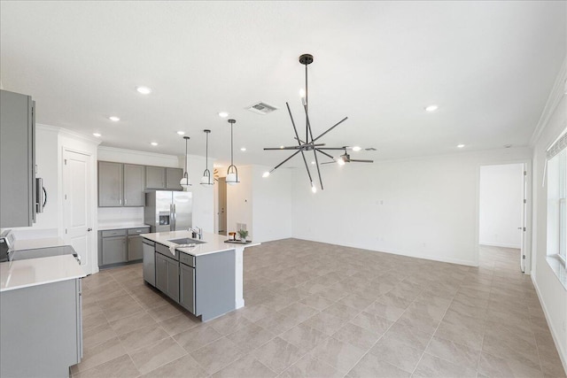 3527 Angler Dr, Fort Pierce, FL 34946 - kitchen featuring gray cabinets, stainless steel appliances, a sink, ornamental molding, and recessed lighting