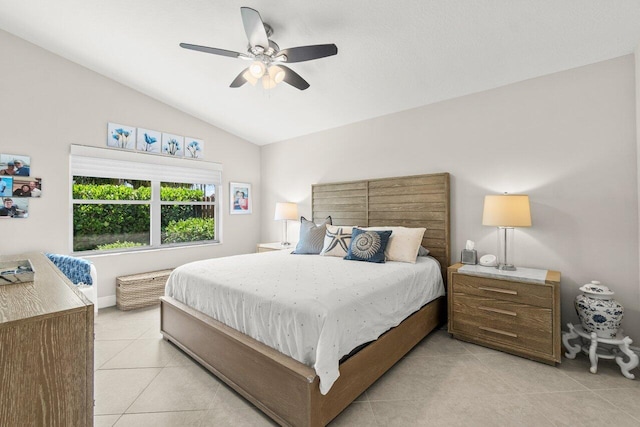 bedroom featuring light tile patterned floors, lofted ceiling, and a ceiling fan