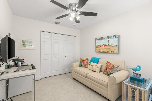 living room with ceiling fan and light tile patterned flooring