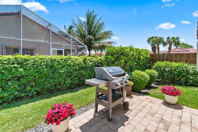 view of patio featuring a lanai and area for grilling