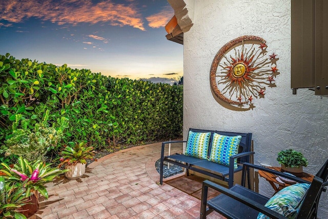 view of patio terrace at dusk