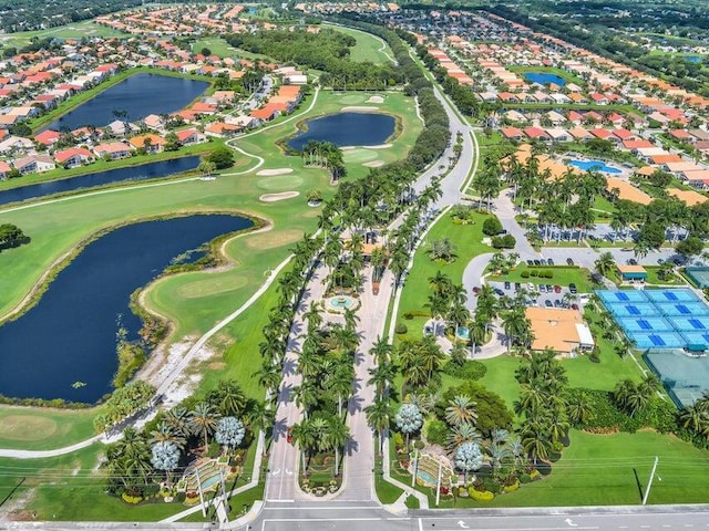 aerial overview of property's location featuring a large body of water, a golf course, and nearby suburban area
