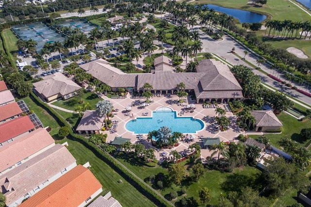 aerial view of property's location with a pool and a large body of water