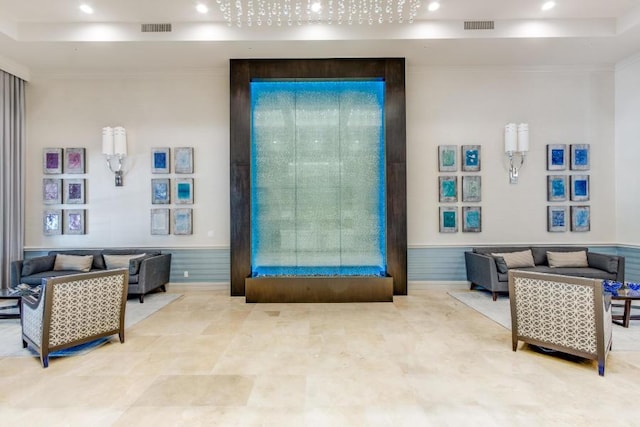 building lobby featuring wainscoting, recessed lighting, and ornamental molding