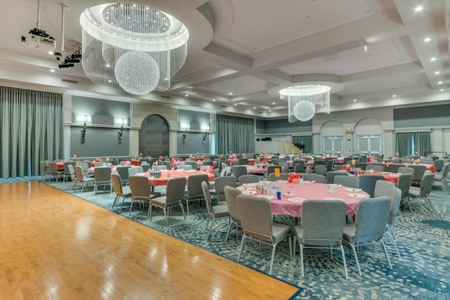 dining space featuring coffered ceiling, hardwood / wood-style floors, beamed ceiling, and a high ceiling
