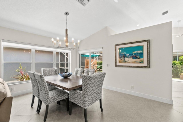 dining area with a chandelier, lofted ceiling, baseboards, and light tile patterned flooring