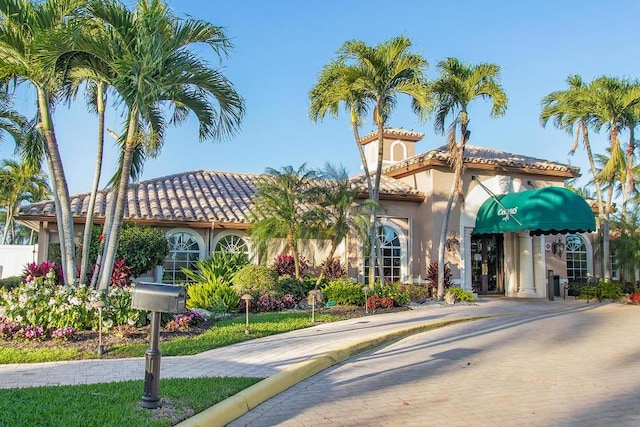 view of front of home featuring a tile roof and stucco siding