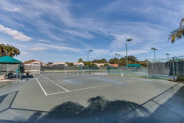 view of tennis court with fence