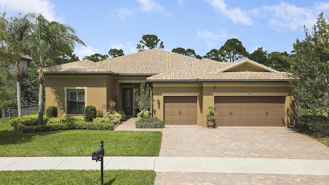 4885 SW Gossamer Cir, Palm City, FL 34990 - view of front facade with an attached garage, decorative driveway, stucco siding, and a tile roof