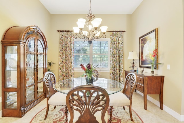 4885 SW Gossamer Cir, Palm City, FL 34990 - dining area featuring a chandelier, baseboards, and light tile patterned flooring