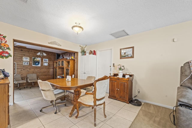 7302 Banyan St, Fort Pierce, FL 34951 - dining room featuring wooden walls, a textured ceiling, baseboards, and light tile patterned floors