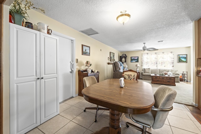 7302 Banyan St, Fort Pierce, FL 34951 - dining room with a textured ceiling, ceiling fan, and light tile patterned floors