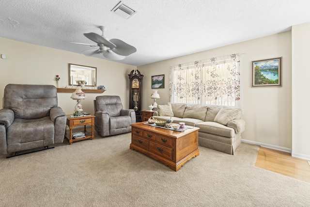 7302 Banyan St, Fort Pierce, FL 34951 - living area featuring light carpet, a ceiling fan, a textured ceiling, and baseboards