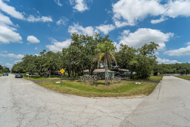 7302 Banyan St, Fort Pierce, FL 34951 - view of asphalt road featuring traffic signs and view of scattered trees