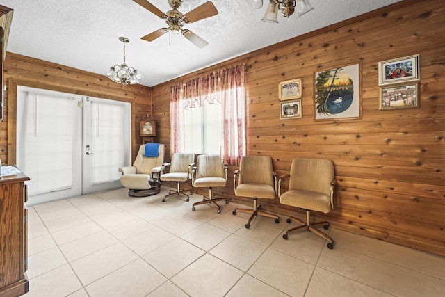 7302 Banyan St, Fort Pierce, FL 34951 - living area featuring wood walls, a textured ceiling, tile patterned flooring, french doors, and ceiling fan
