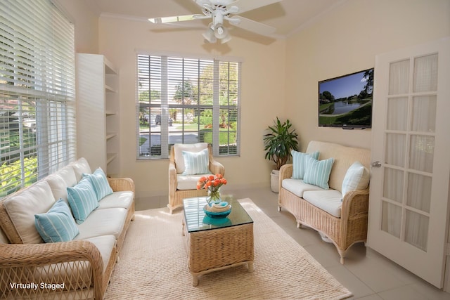 living room with crown molding, ceiling fan, and light tile patterned floors