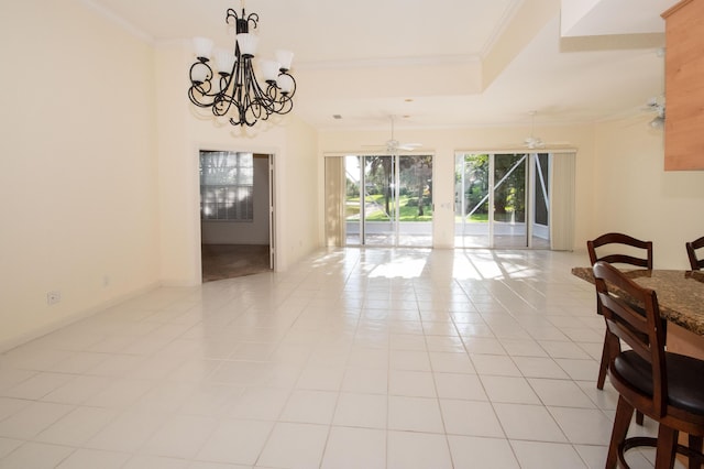 dining room featuring a chandelier, ornamental molding, a tray ceiling, light tile patterned floors, and a ceiling fan