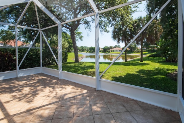 unfurnished sunroom featuring a water view