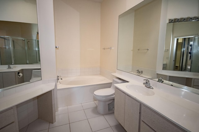 full bath featuring a shower stall, tile patterned floors, a garden tub, toilet, and vanity