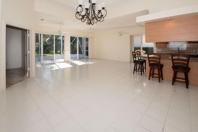 dining space featuring ceiling fan, a chandelier, crown molding, and light tile patterned floors